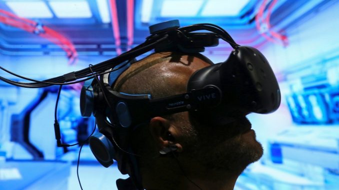 Pablo Holcer tests out a virtual reality system made by Neurable at SIGGRAPH 2017 in Los Angeles, California